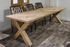 Long wooden dining table in a brick setting