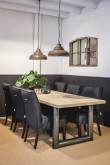 Dining table with wooden top and black chairs