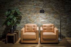 Two cognac-coloured armchairs as an ensemble
