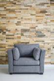 Dark grey upholstered armchair in front of a wooden slat wall