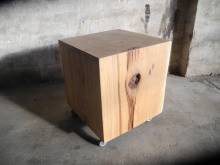 Wooden stool with a striking knot in side light